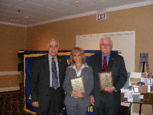 In October, Makrinos (l) honors Maryann and Joe Pucilowski with AFCEAN of the Quarter awards for 2007.
